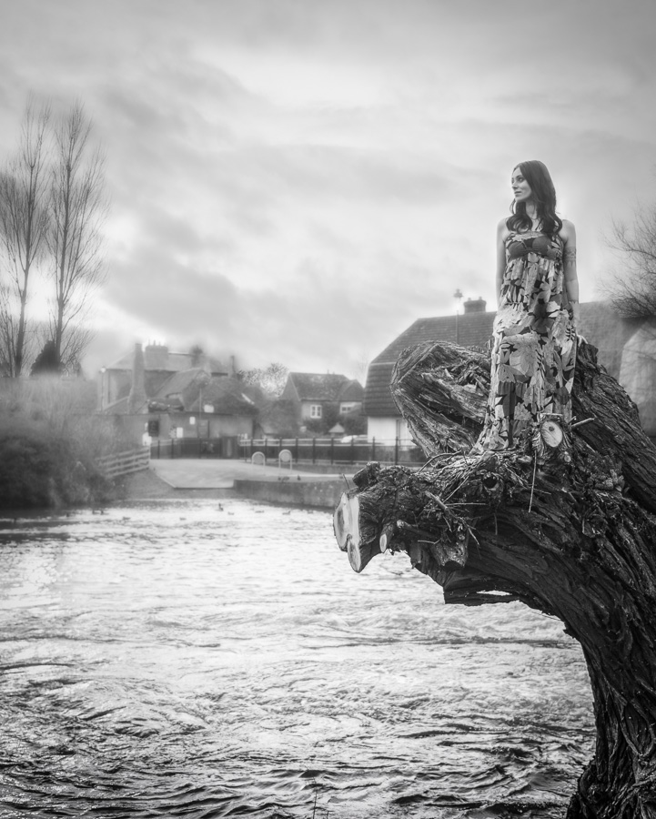 Girl on the tree stump near Old Mill. BW