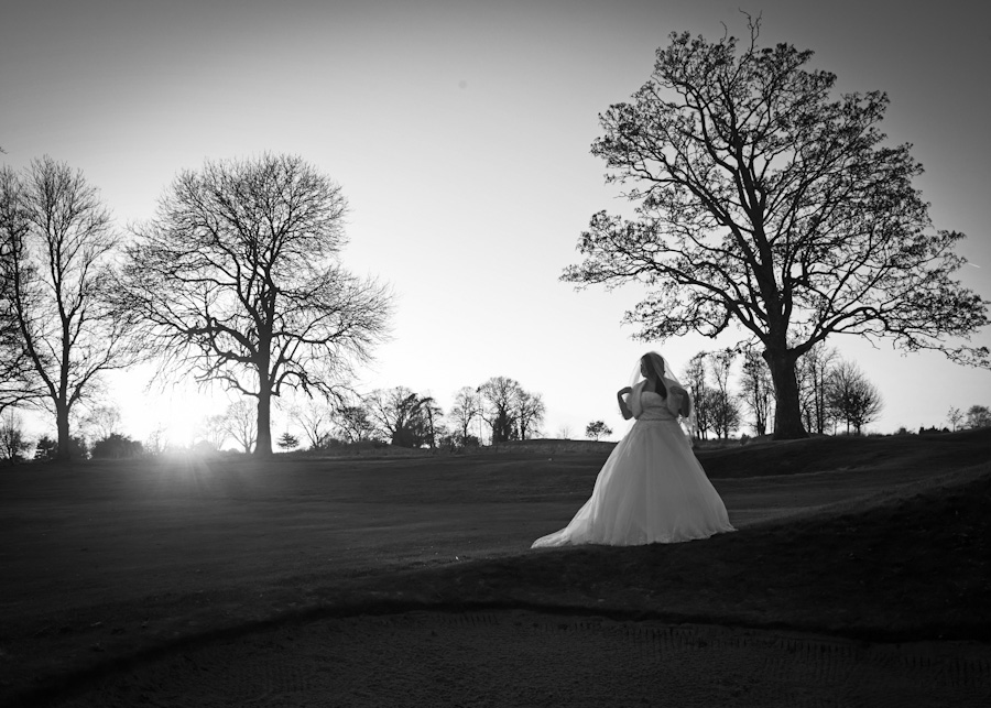 Wedding at Badgemore Golf Club. Bride on the sunset in Black and White